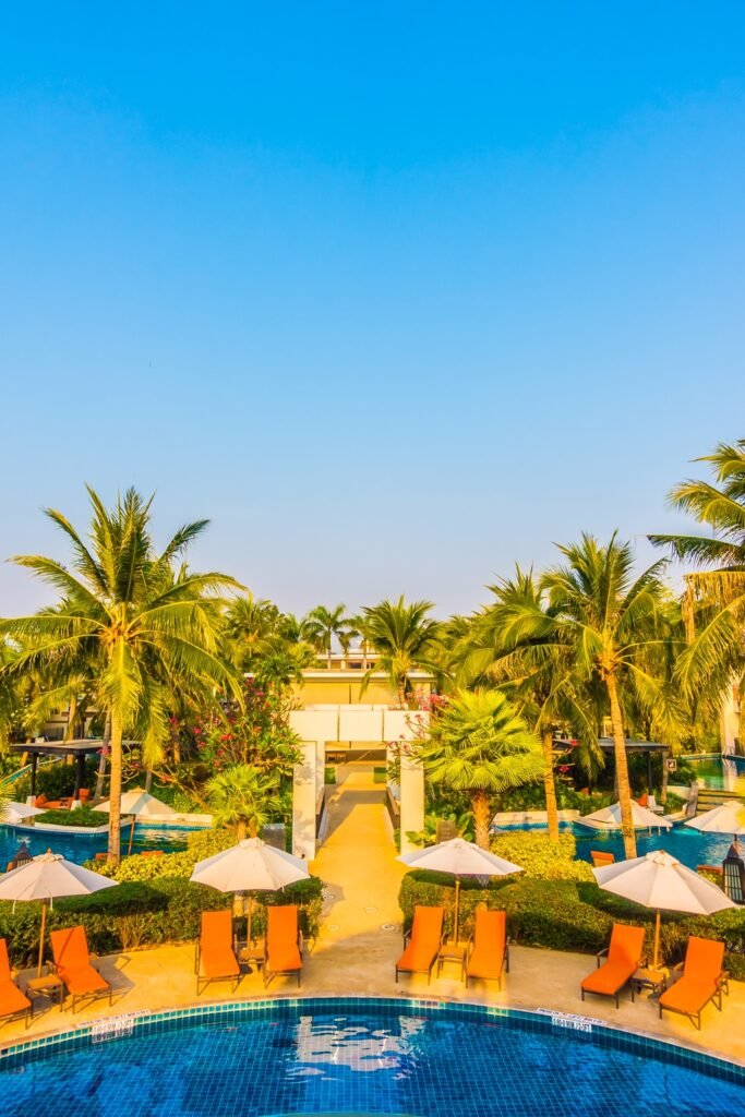 Empty Umbrella and chair around swimming pool in hotel resort